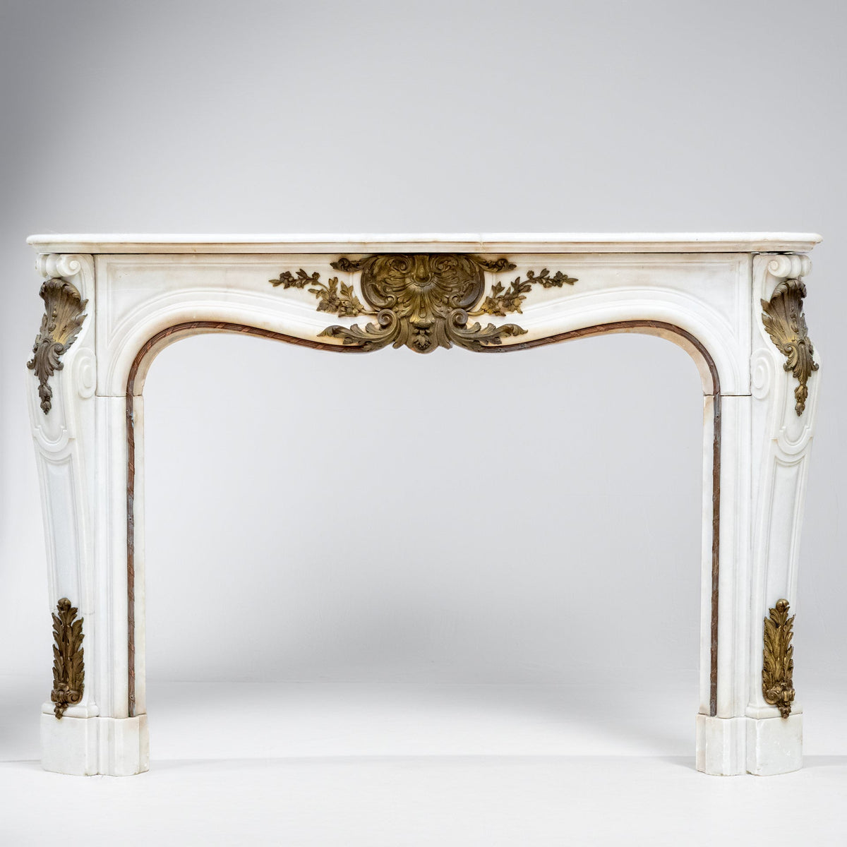 Antique French Louis XV Style Statuary Marble Fireplace with Brass Mounts | The Architectural Forum