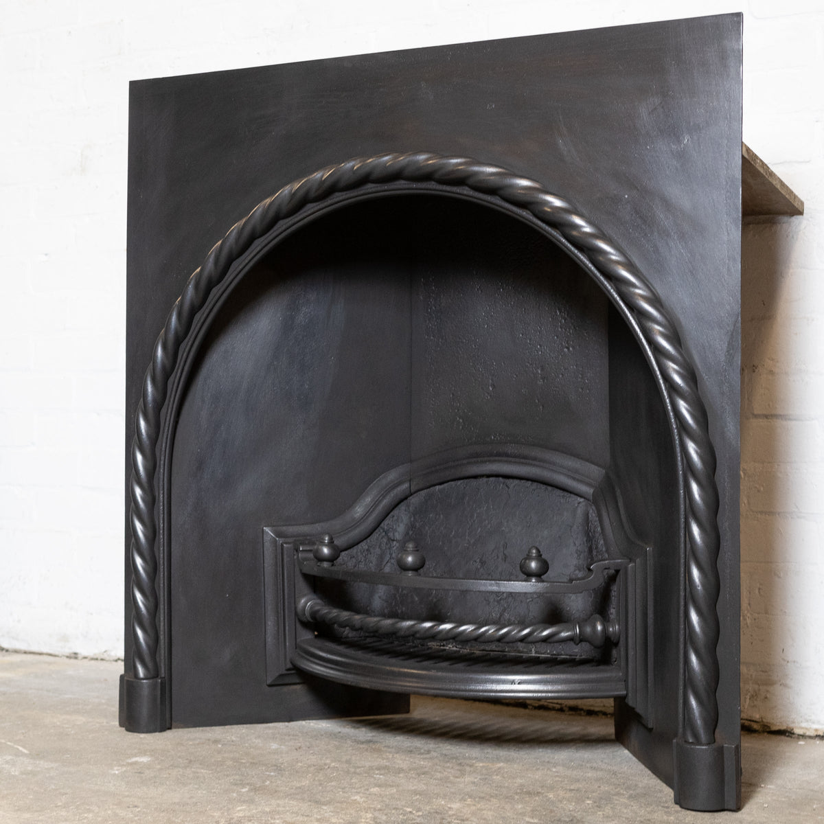 Antique Cast Iron Arched Fireplace Insert with Rope Detail | The Architectural Forum
