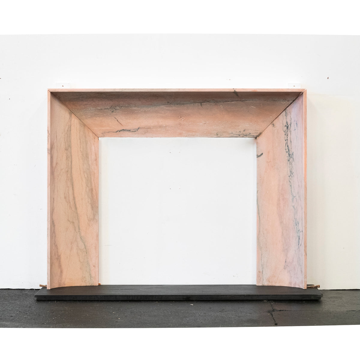 Bolection Fireplace Surround in Reclaimed Pink Marble | The Architectural Forum