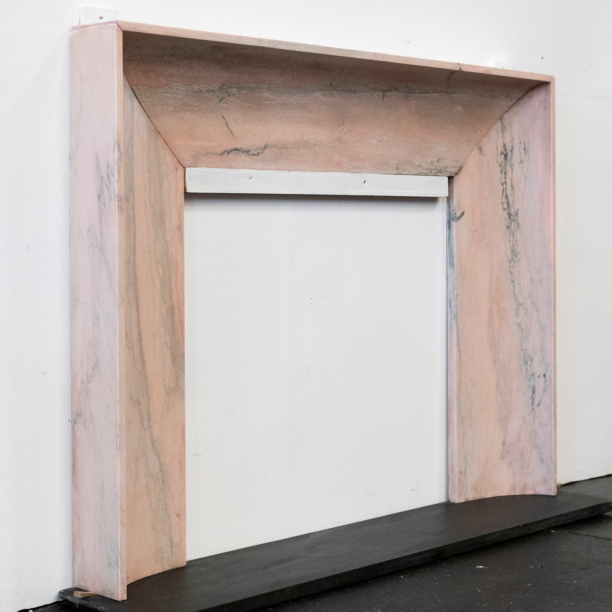 Bolection Fireplace Surround in Reclaimed Pink Marble | The Architectural Forum