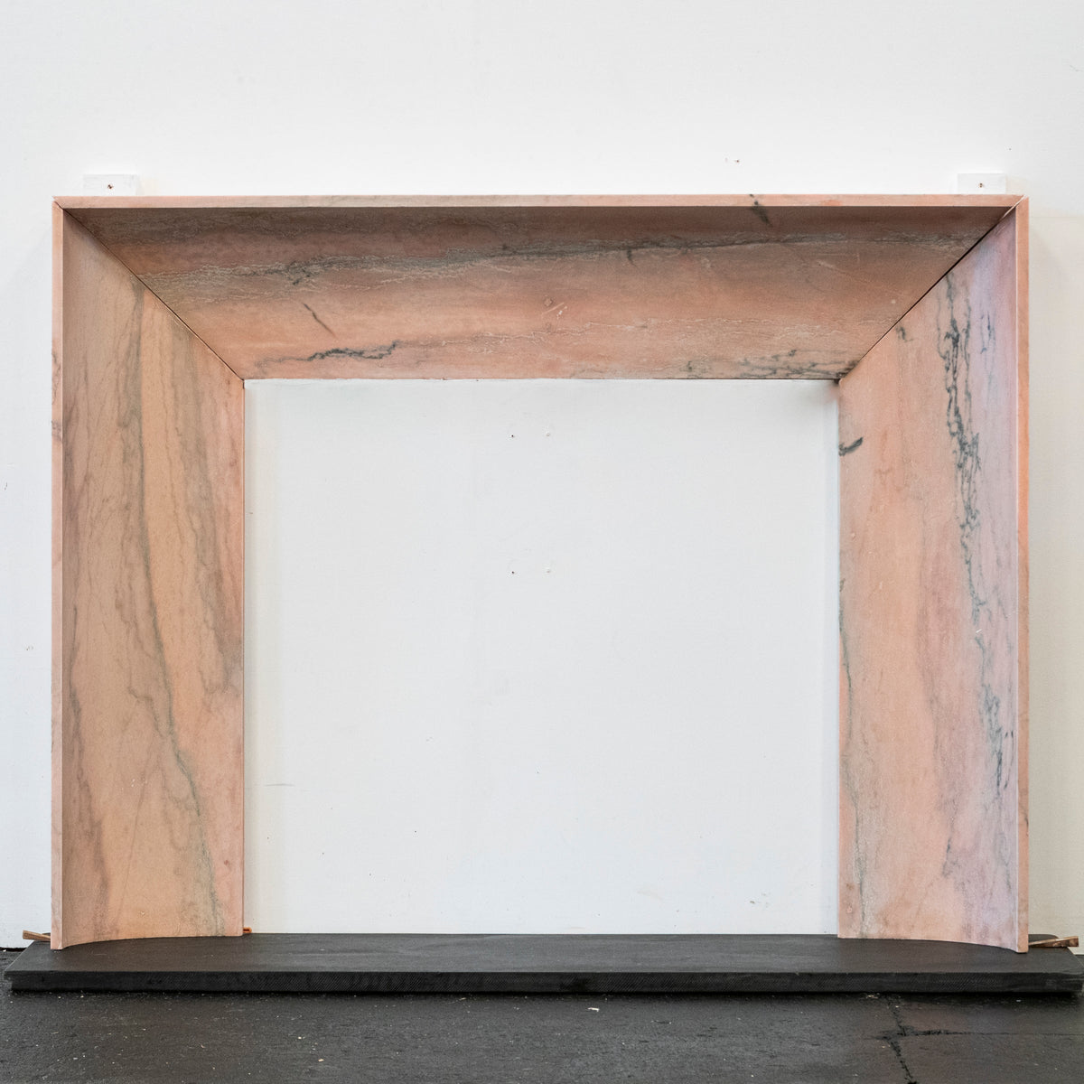 Bolection Fireplace Surround in Reclaimed Pink Marble | The Architectural Forum